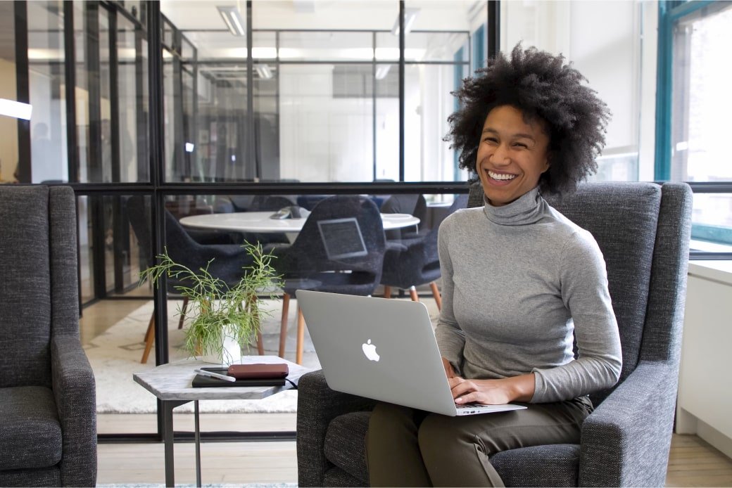 Woman with laptop in modern office